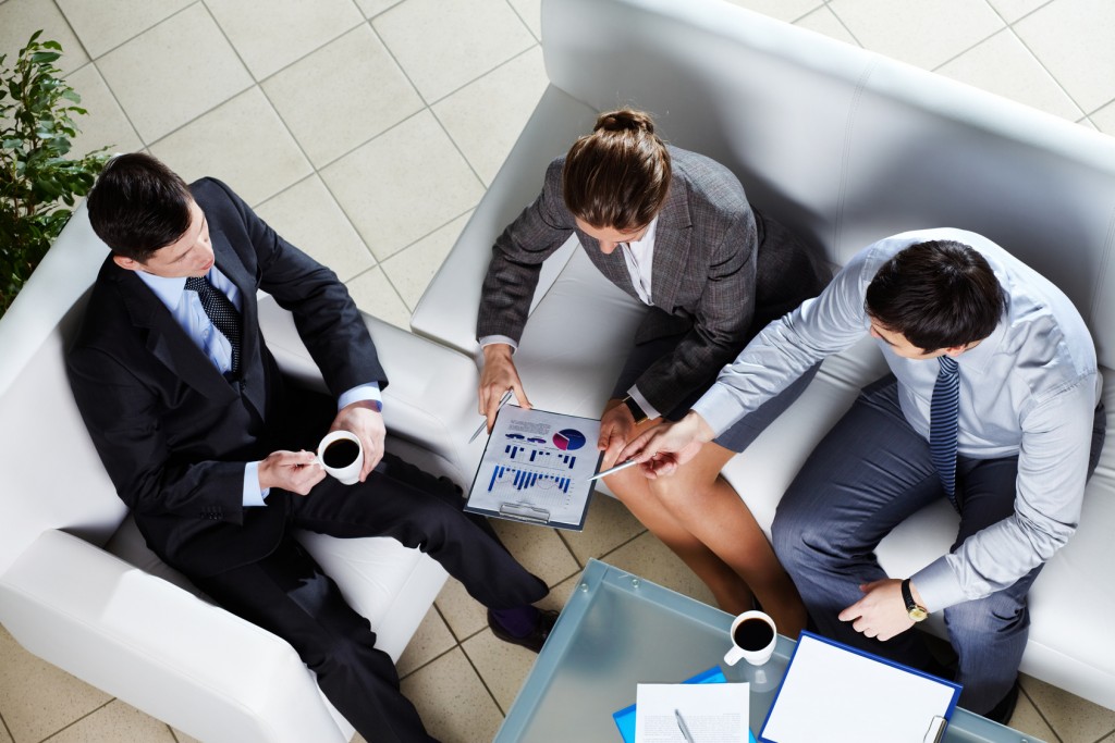 Overview of business team discussing the results of a new strategy